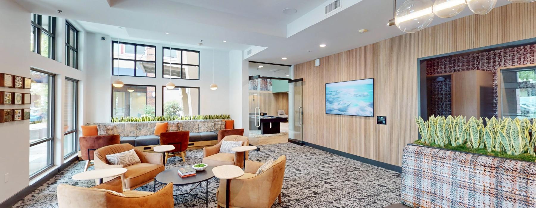 a room with a couch and chairs